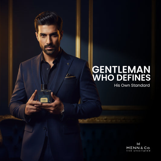 Man in a suit holding a perfume bottle with text 'Gentleman Who Defines His Own Standard' and brand logo.