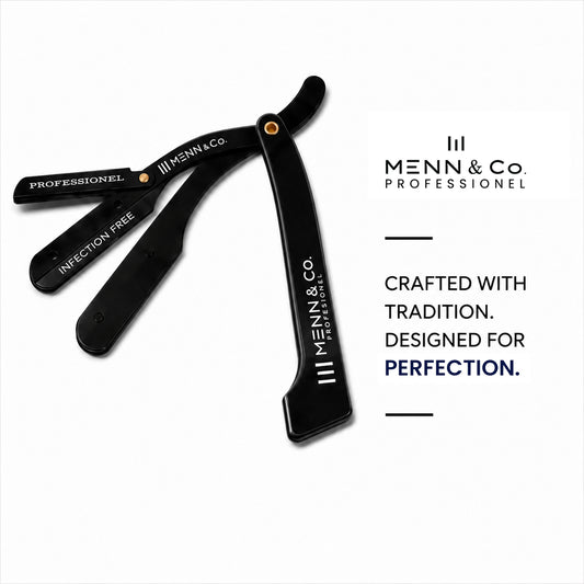 A black Menn & Co. professional straight razor shown open on a white background, with the brand logo and the text 'Crafted with Tradition.