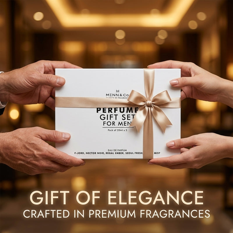 Two hands holding a perfume gift set for men with a blurred background