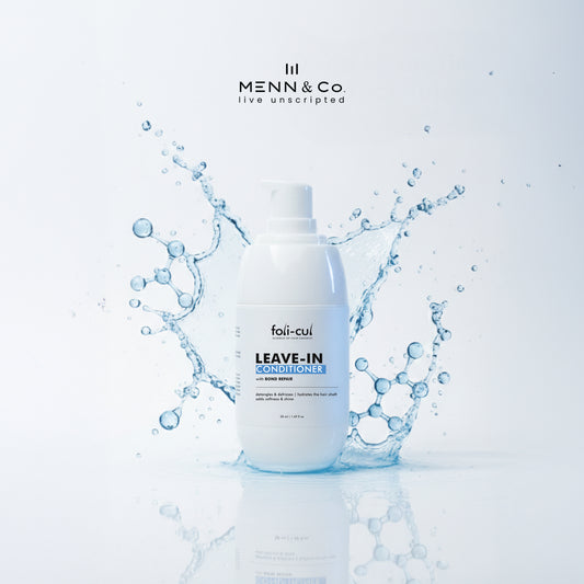 Menn & Co Foli-Cul leave-in conditioner bottle with water splashes on a light blue background