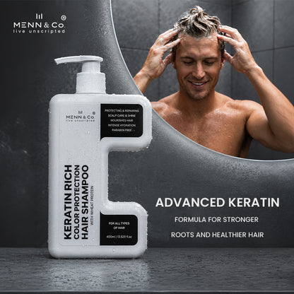 Menn & Co Keratin Rich Color Protection Hair Shampoo bottle shown in front of a shower scene with a shirtless man washing his hair. The bottle is white with black text and black label blocks, and the background is a dark gray bathroom/shower setting.