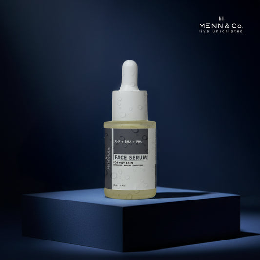 AHA BHA PHA Face serum bottle with dropper on a dark blue background, featuring the Menn & Co brand. For Oily Skin