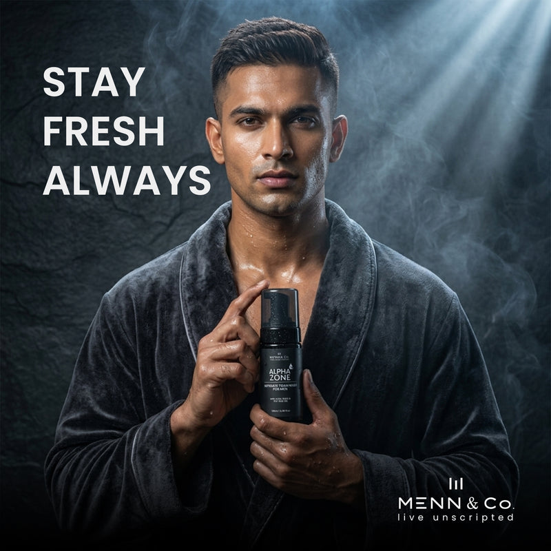 Man holding a bottle of Menn & Co Alpha Zone Intimate Foam wash with 'Stay Fresh Always' text on a dark background.