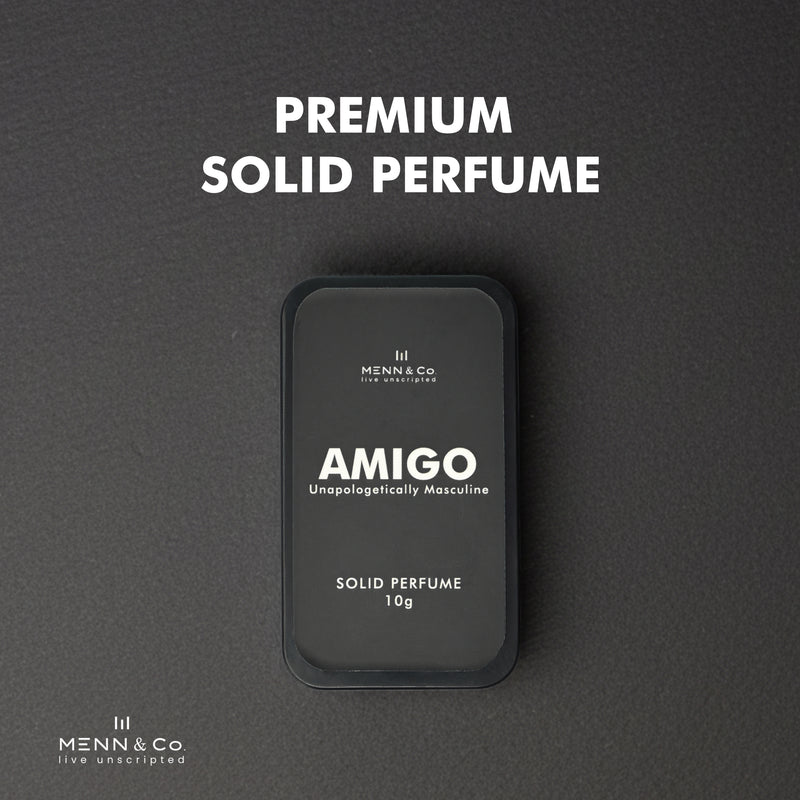 Amigo solid perfume container with 'Menn & Co' branding on a gray background