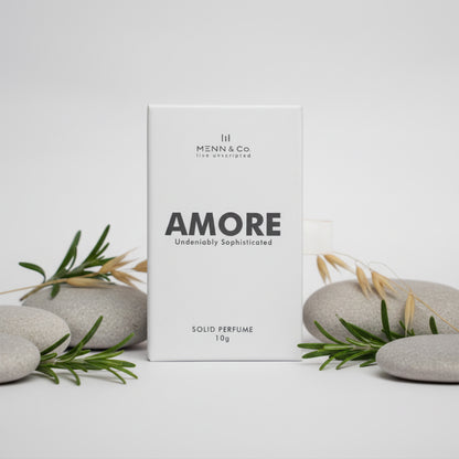 Menn & Co AMORE solid perfume packaging with stones and rosemary on a light background
