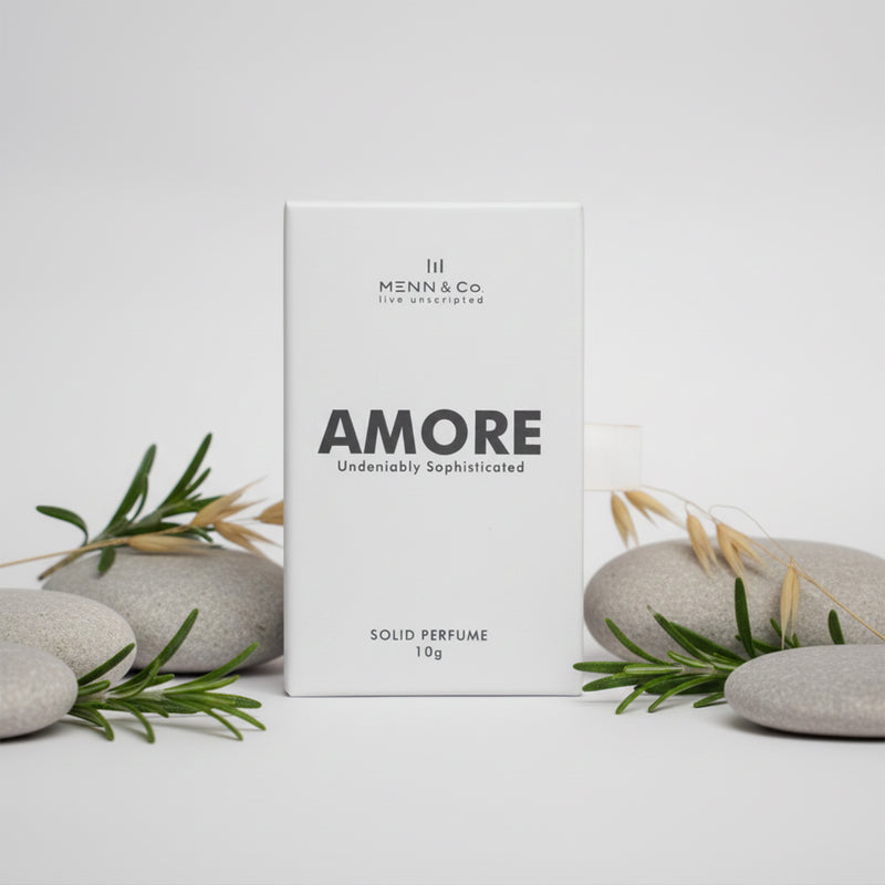 Menn & Co AMORE solid perfume packaging with stones and rosemary on a light background