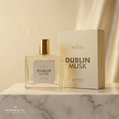 Menn & Co Dublin Musk perfume bottle and packaging on a marble surface with a beige background.