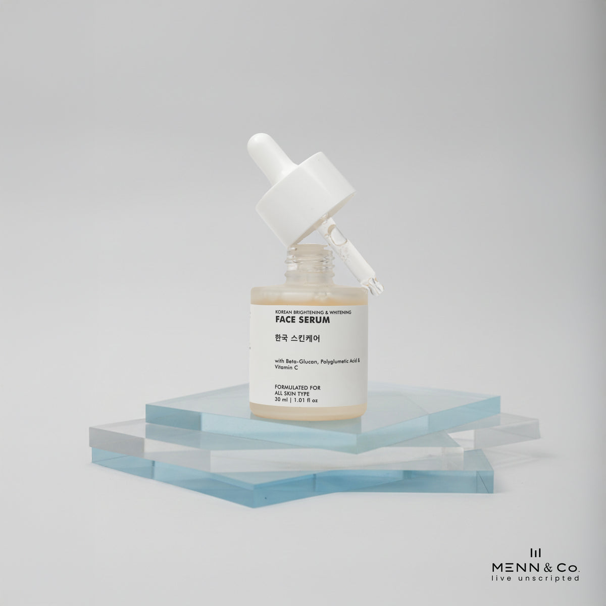 Korean Skin Brightening Face serum bottle on a geometric shelf with a plain background