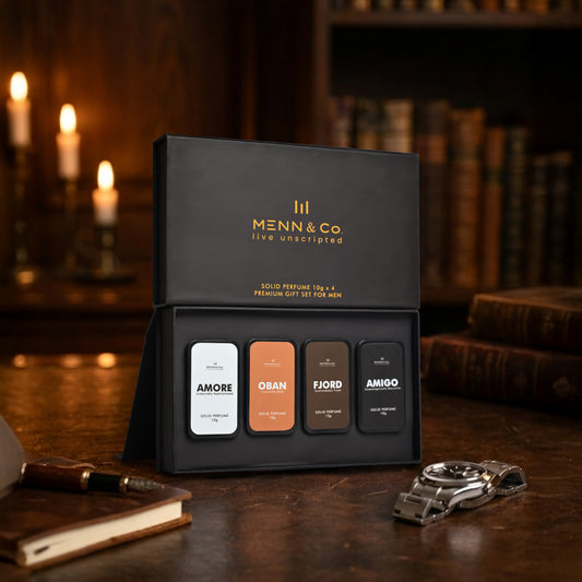 Menn & Co solid perfume Amore, Amigo, Oban, Fjord set on a wooden surface with candles and books in the background