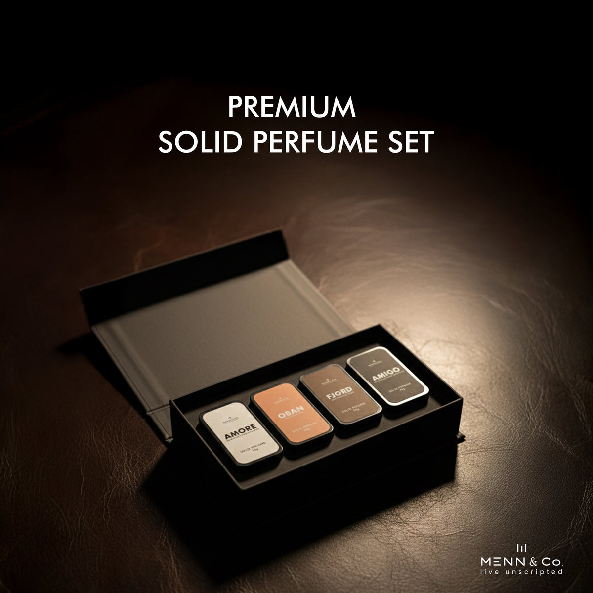 Premium solid perfume set with four different colored containers in an open black box on a dark background.