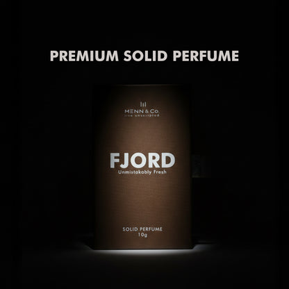 Menn & Co Fjord solid perfume packaging on a dark background