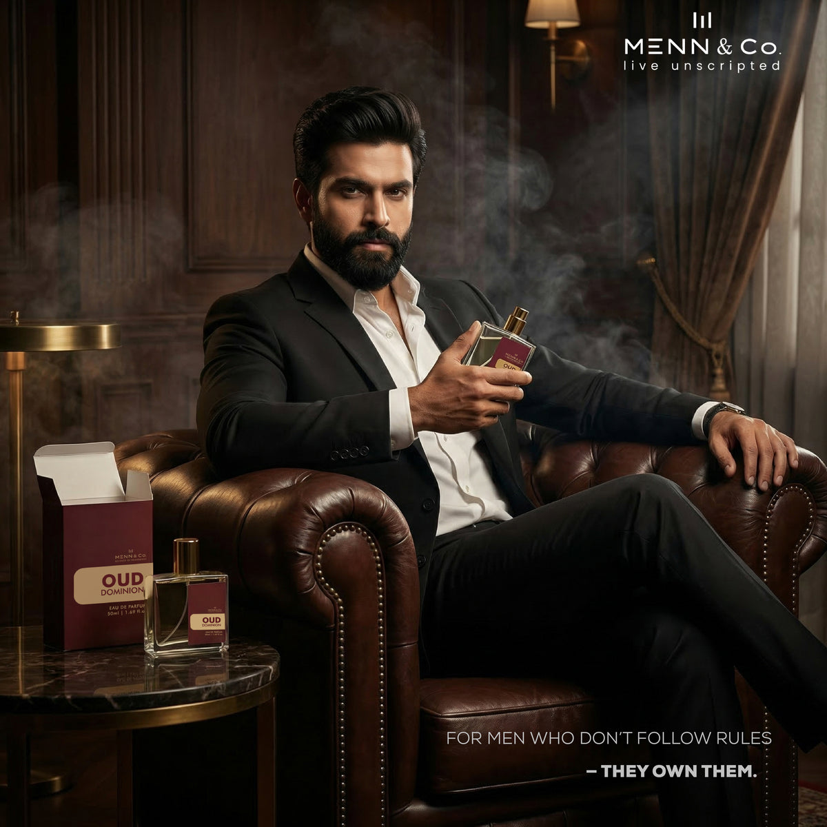 Man in a suit holding a Oud Dominion perfume bottle in a luxurious room with 'Menn & Co' branding.