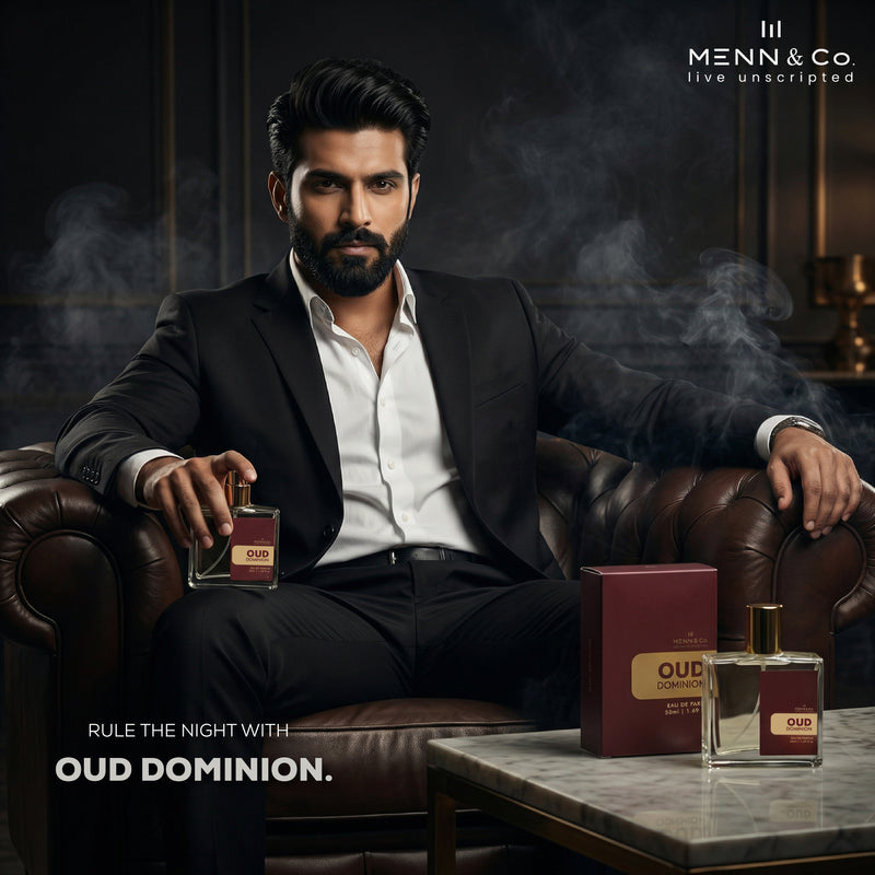 Man in a suit holding a Menn & Co Oud Dominion perfume bottle with 'Menn & Co' branding.