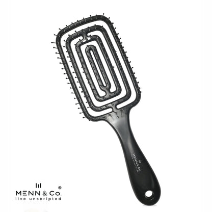 A black hairbrush with a rectangular head, ridged bristles, and a contoured handle, shown on a white background with the MENN & Co logo in the bottom-left corner.
