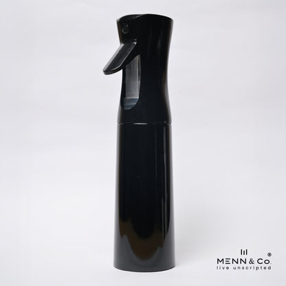 A glossy black spray bottle with a trigger nozzle and a clear water reservoir, shown against a plain white background with a 'MENN & CO' watermark in the bottom right corner.