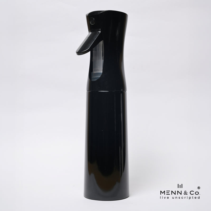 A glossy black spray bottle with a trigger nozzle and a clear water reservoir, shown against a plain white background with a 'MENN & CO' watermark in the bottom right corner.