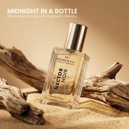 Menn & Co Nectar Noir perfume bottle on sand with driftwood, labeled 'Midnight in a Bottle'.