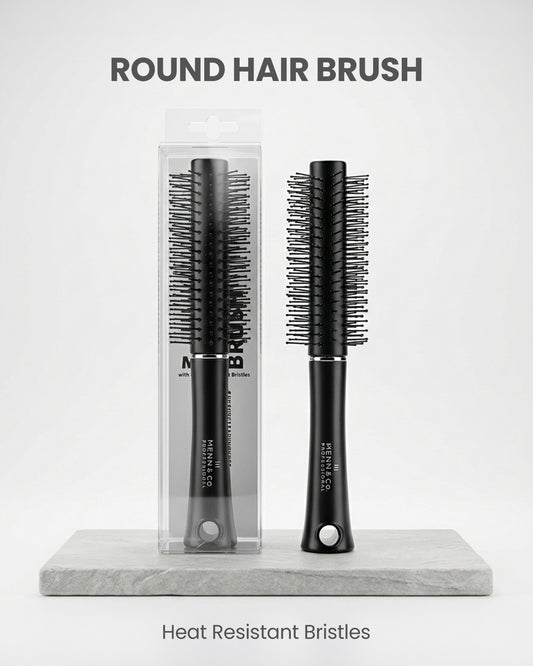 Round hair brush with packaging on a marble stand against a white background