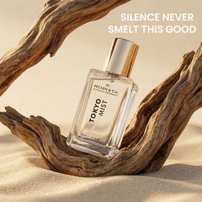 Perfume bottle labeled 'Tokyo Mist' by Mennen & Co on a wooden surface with sand.