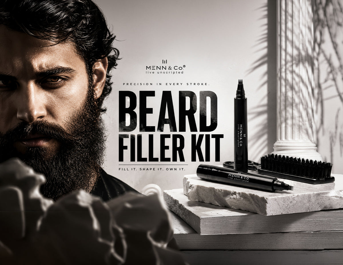Menn & Co Beard Filler Kit featuring black marker pens, a black grooming brush, and a black comb tool arranged on stacked stone slabs next to a close-up portrait of a bearded man.