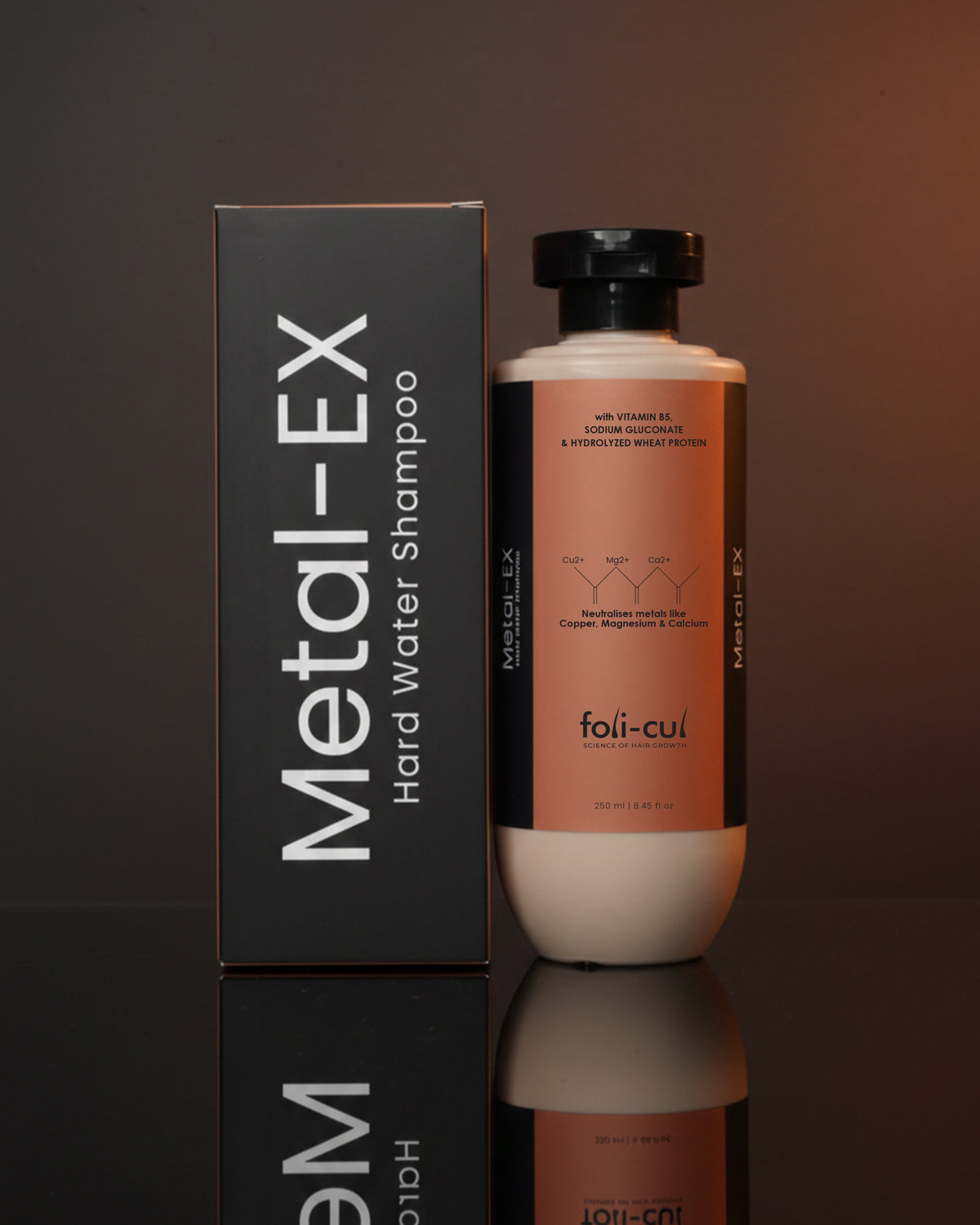 Metal-EX hard water shampoo bottle and packaging on a reflective surface with a dark background
