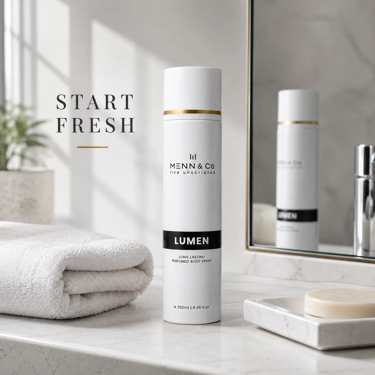 Menn & Co Lumen body spray on a bathroom counter with towel and soap.