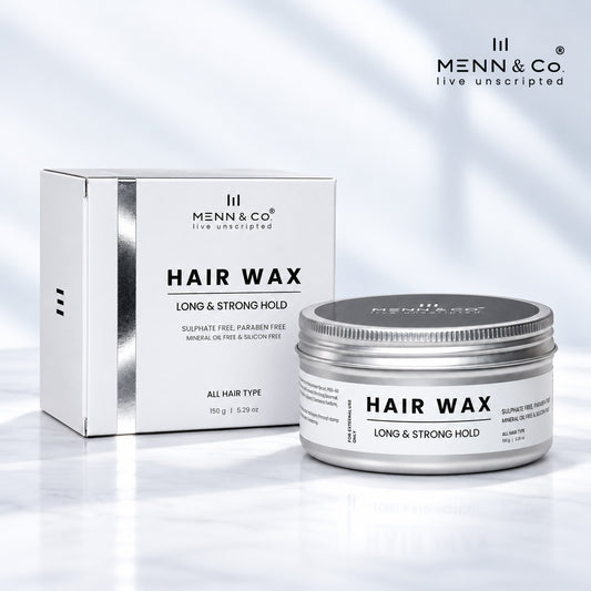 Menn & Co Hair Wax Long & Strong Hold hair wax shown in a white box and a silver jar with a white label, on a light blue-white reflective surface with the Menn & Co logo in the top right corner.