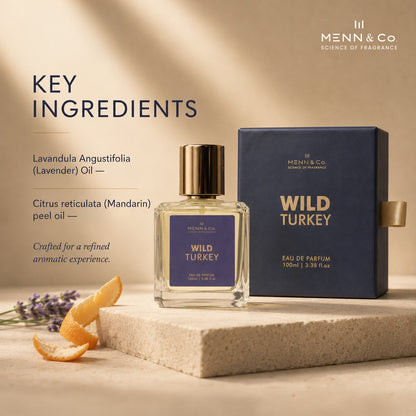 Menn & Co Wild Turkey Eau de Parfum 100ml bottle and its navy blue box, styled on a beige stone pedestal with lavender and orange slices against a warm beige background with text detailing key ingredients.