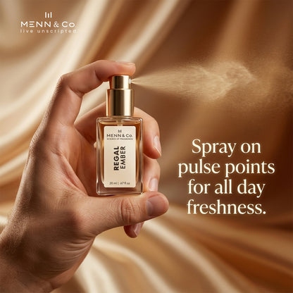 Hand holding a Menn & Co. perfume bottle with a brown fabric background